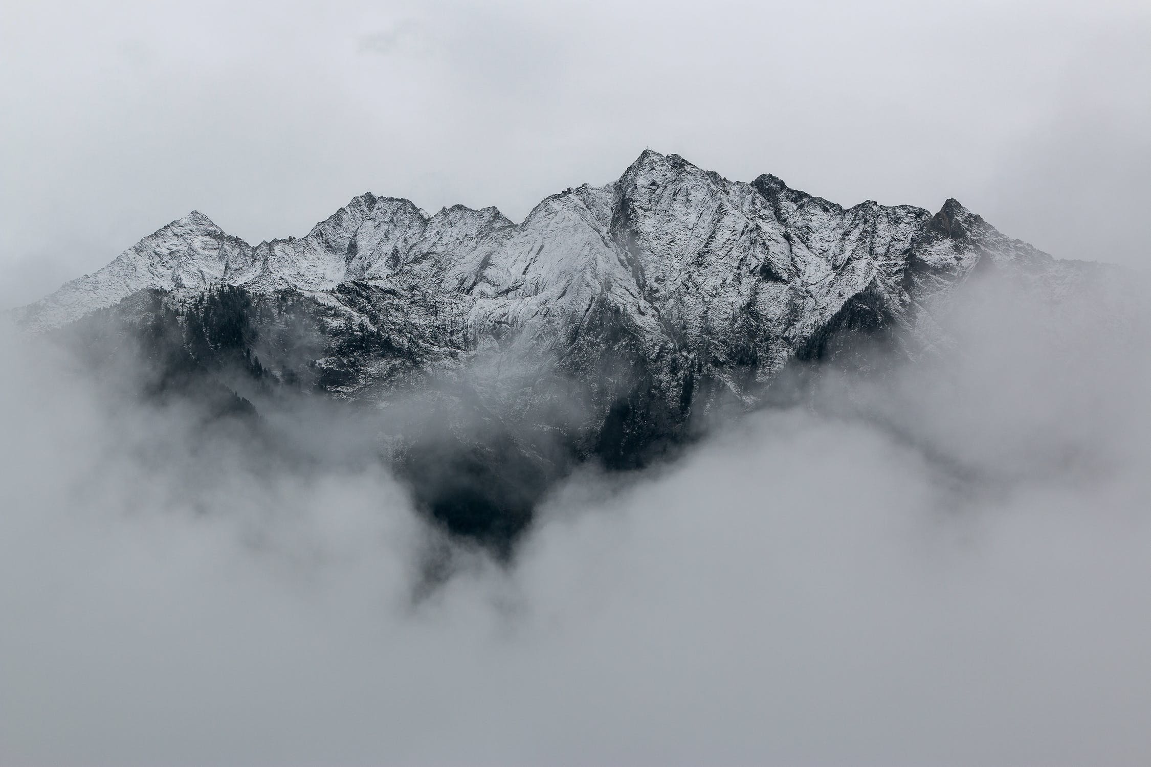 Snowy peaks emerging from a sea of clouds